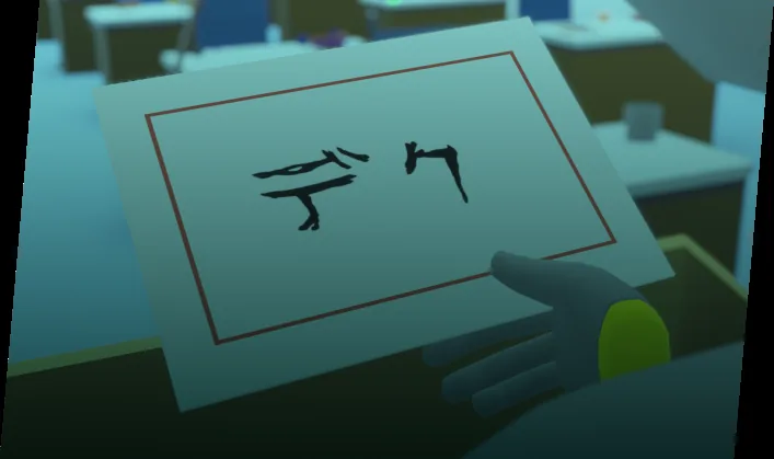机の上に置かれた「デク」と書かれた紙を手に取っている場面